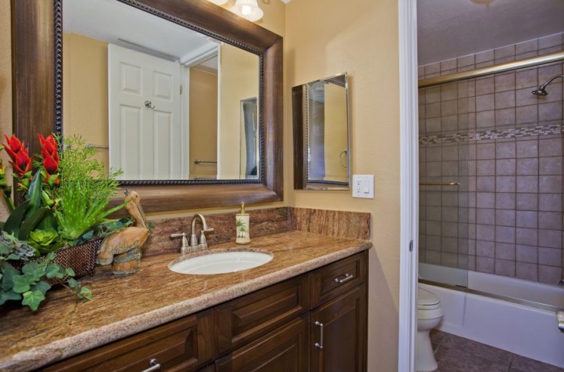E101 warm toned bathroom vanity with granite counter tops